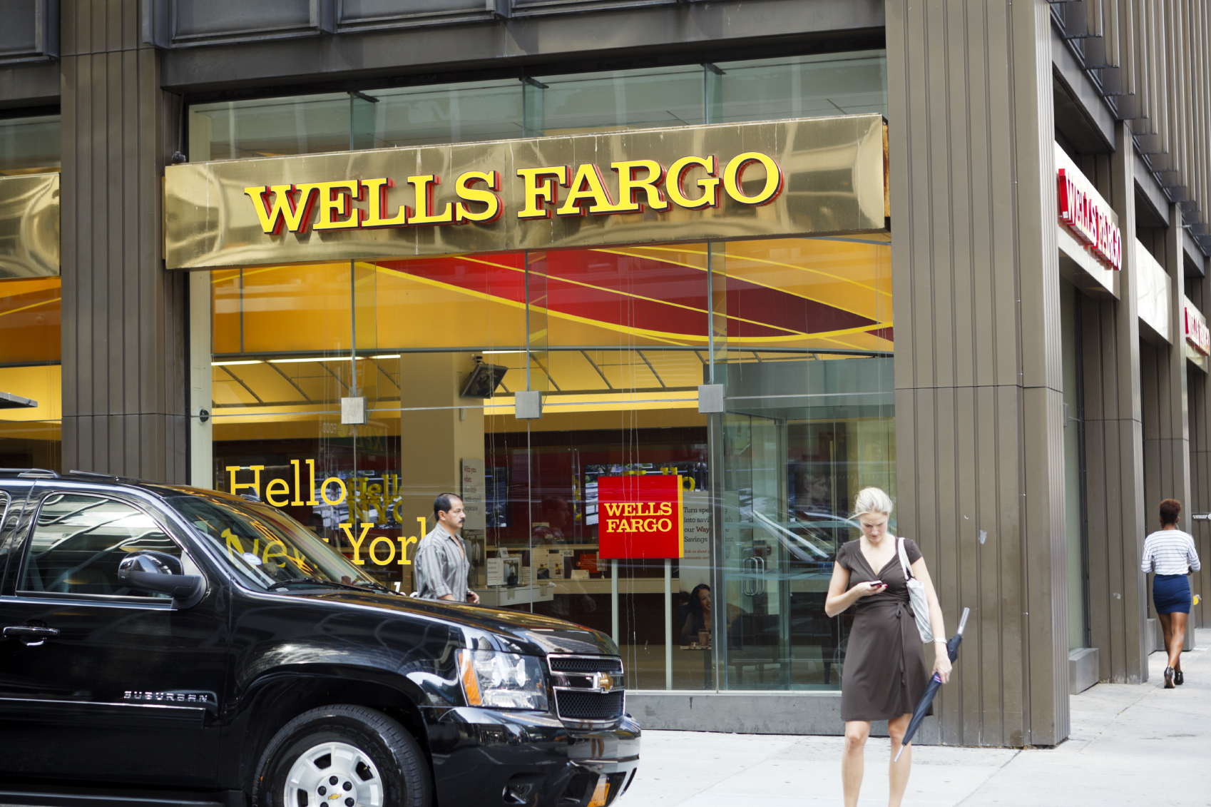 New York, New York, USA - August 18, 2011: A Wells Fargo Bank branch on 3rd avenue in Manhattan. A woman can be seen checking her phone as well as two other pedestrians. [url=/my_lightbox_contents.php?lightboxID=3623142]Click here for more[/url] New York images and video.