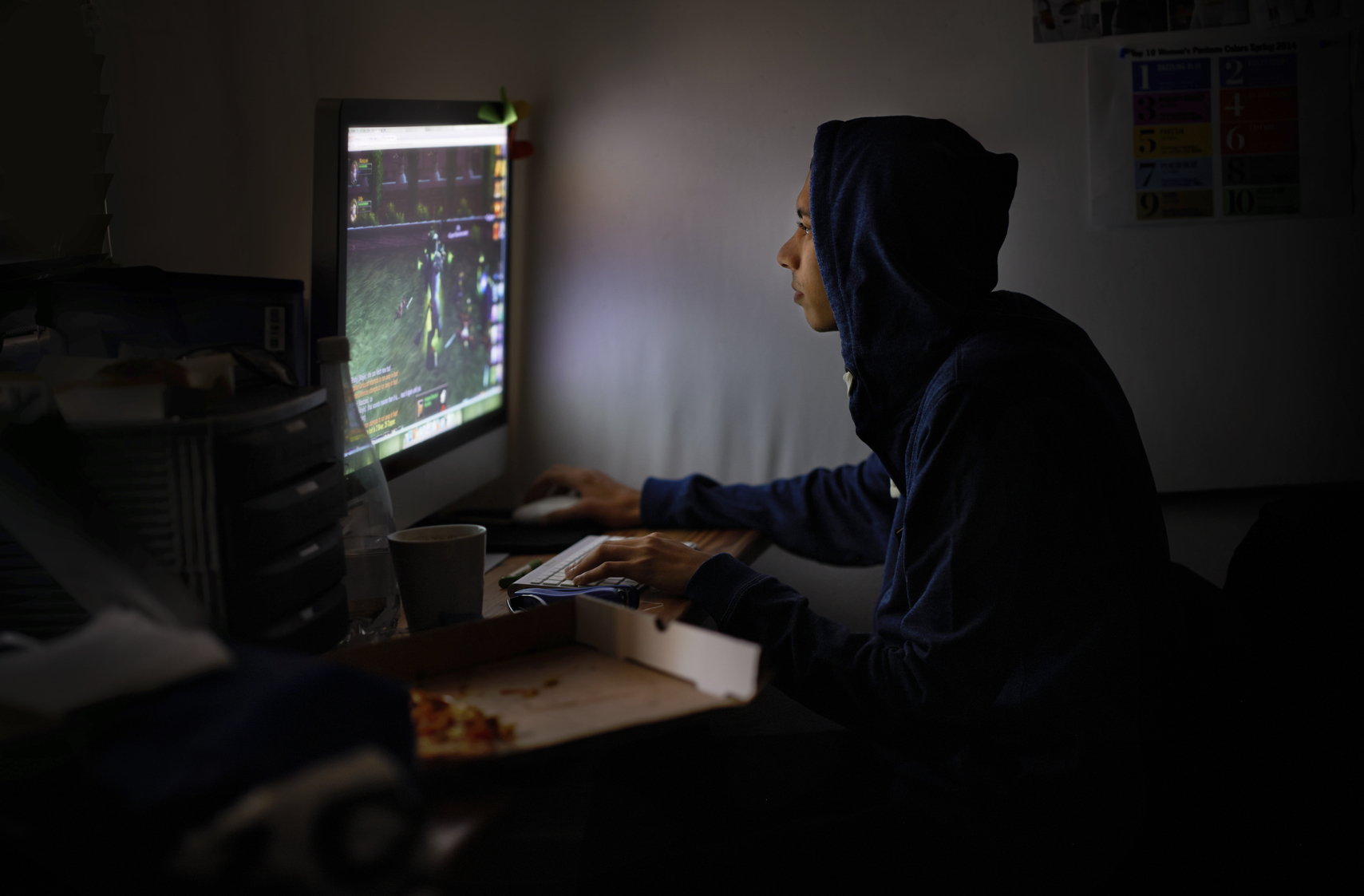 Shot of a young gamer focused on his game - ALL screen content on this image is created from scratch by Yuri Arcurs'  team of professionals for this particular photo shoothttp://195.154.178.81/DATA/i_collage/pi/shoots/783867.jpg